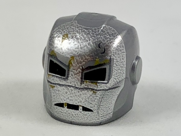 Minifigure, Headgear Helmet Armor Plates and Ear Protectors with Silver Face, Dark Tan Rust Spots, Black Eye and Mouth Holes Pattern