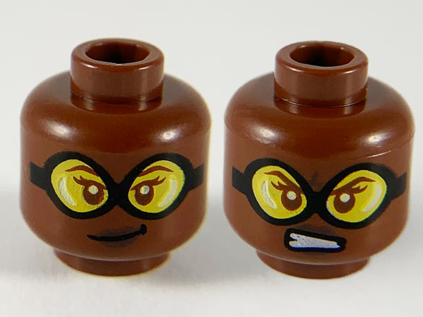 Minifigure, Head Dual Sided Female, Black Goggles with Yellow Lenses, Dark Brown Lips, Lopsided Grin / Scowl Showing Teeth Pattern