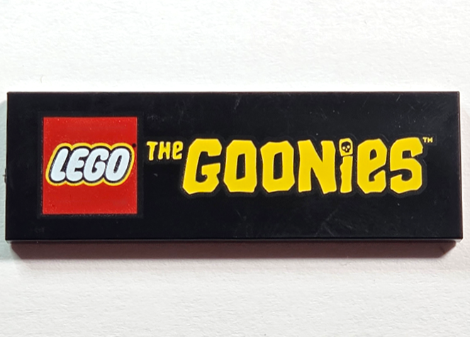 Tile 2 x 6 with LEGO Logo and Yellow 'THe GOONieS' Pattern