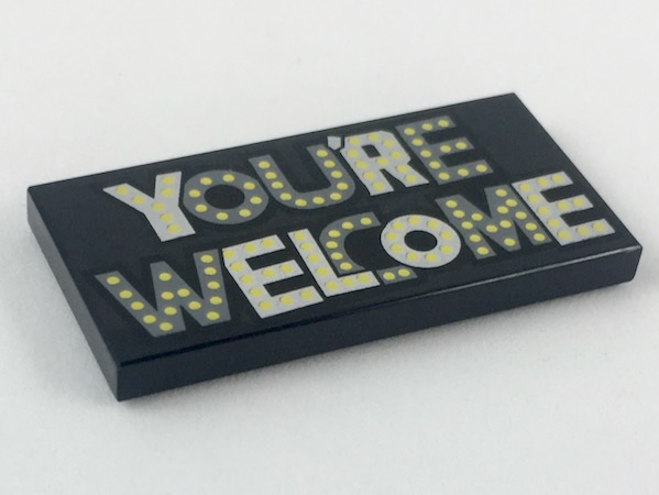 Tile 2 x 4 with Silver and Dark Bluish Gray 'YOU'RE WELCOME' with Yellow Spots Pattern